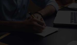 Writing hand with laptop - Dark - Big
