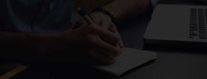Writing hand with laptop - Dark - Big banner
